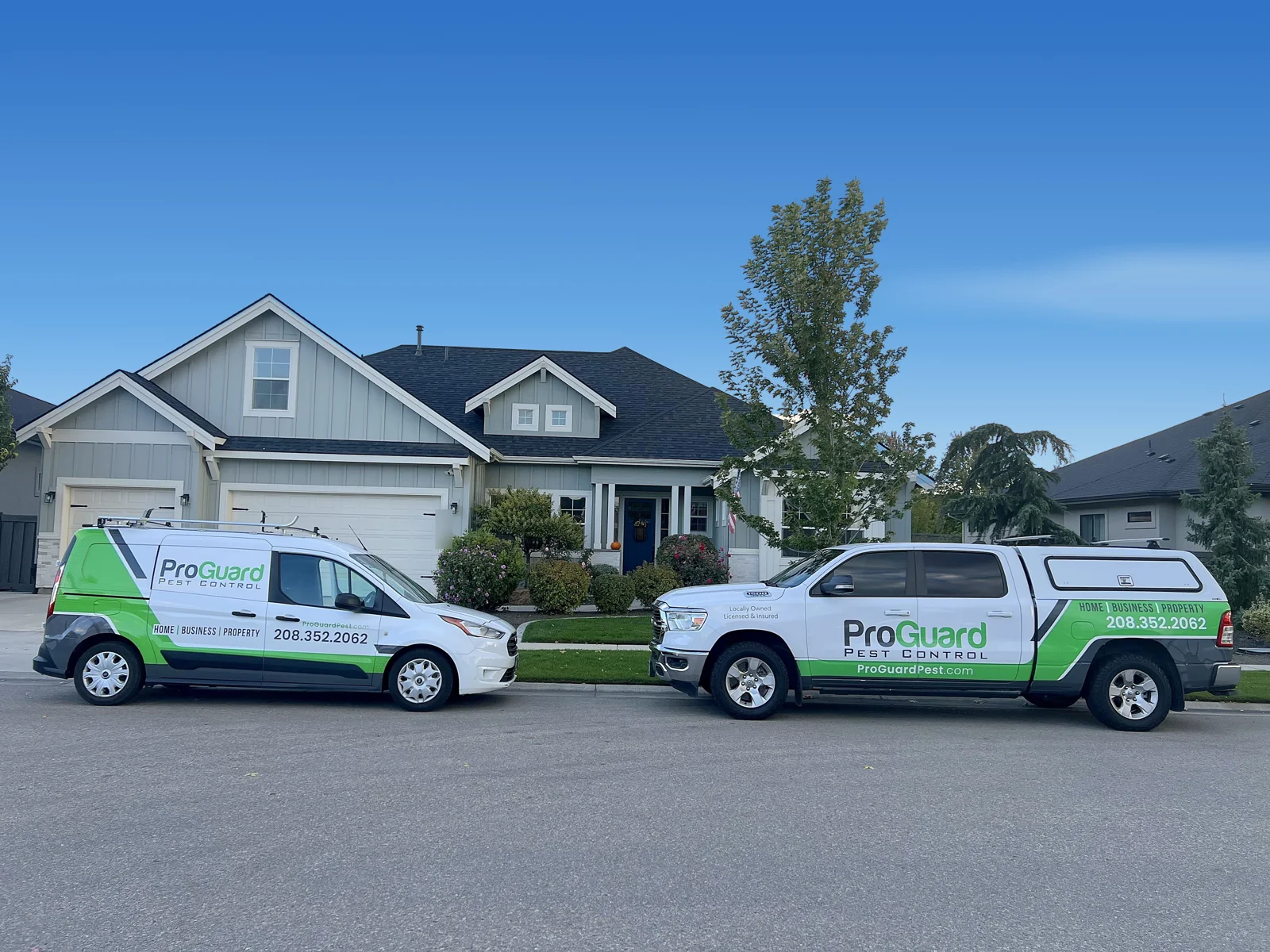 ProGuard Pest Control van and pickup truck parked in front of a home in the Treasure Valley